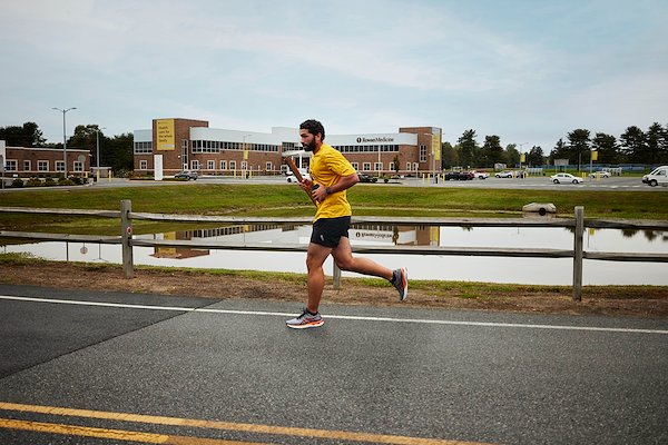 Alumnus Collin Cardona carried the torch through the Rowan-Virtua campus in Sewell.