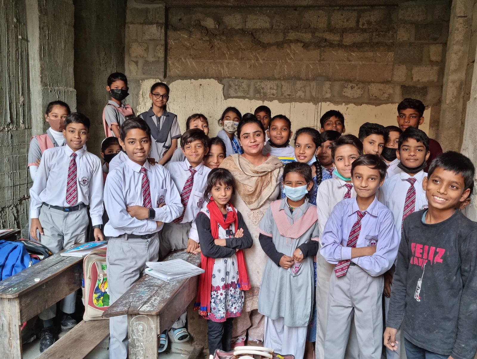 Ayesha with Grade 4 and 5 students. Not originally from Azam Basti, she has been teaching at the school ever since she got married and moved to this locality.