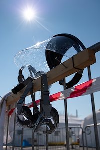 Cleaned and disinfected goggles and face shields dry in the sun, taking advantage of UV light as an additional disinfection measure.