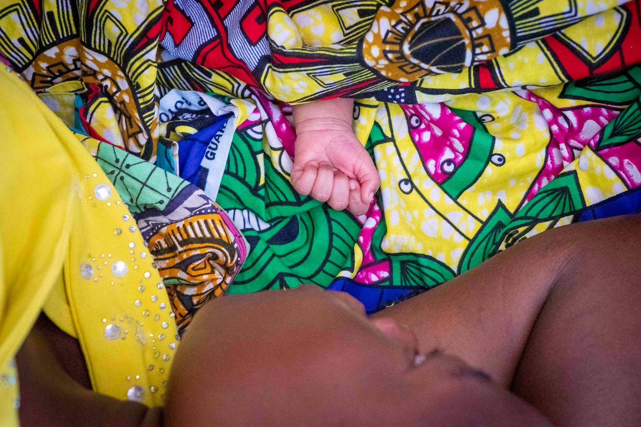 The hand of a newborn baby who is sleeping on the floor next to her mother at the Kotoni health centre.