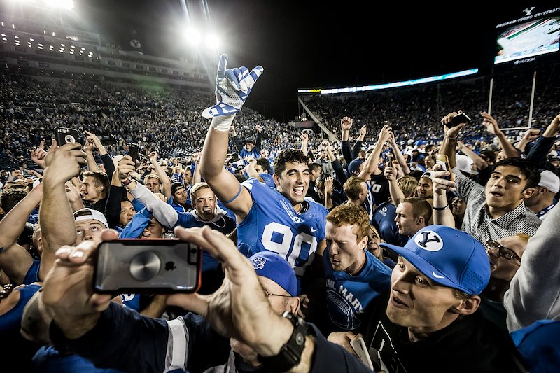Fans rush the field after the Cougars win against Mississippi State - Photo by Jaren Wilkey/BYU
