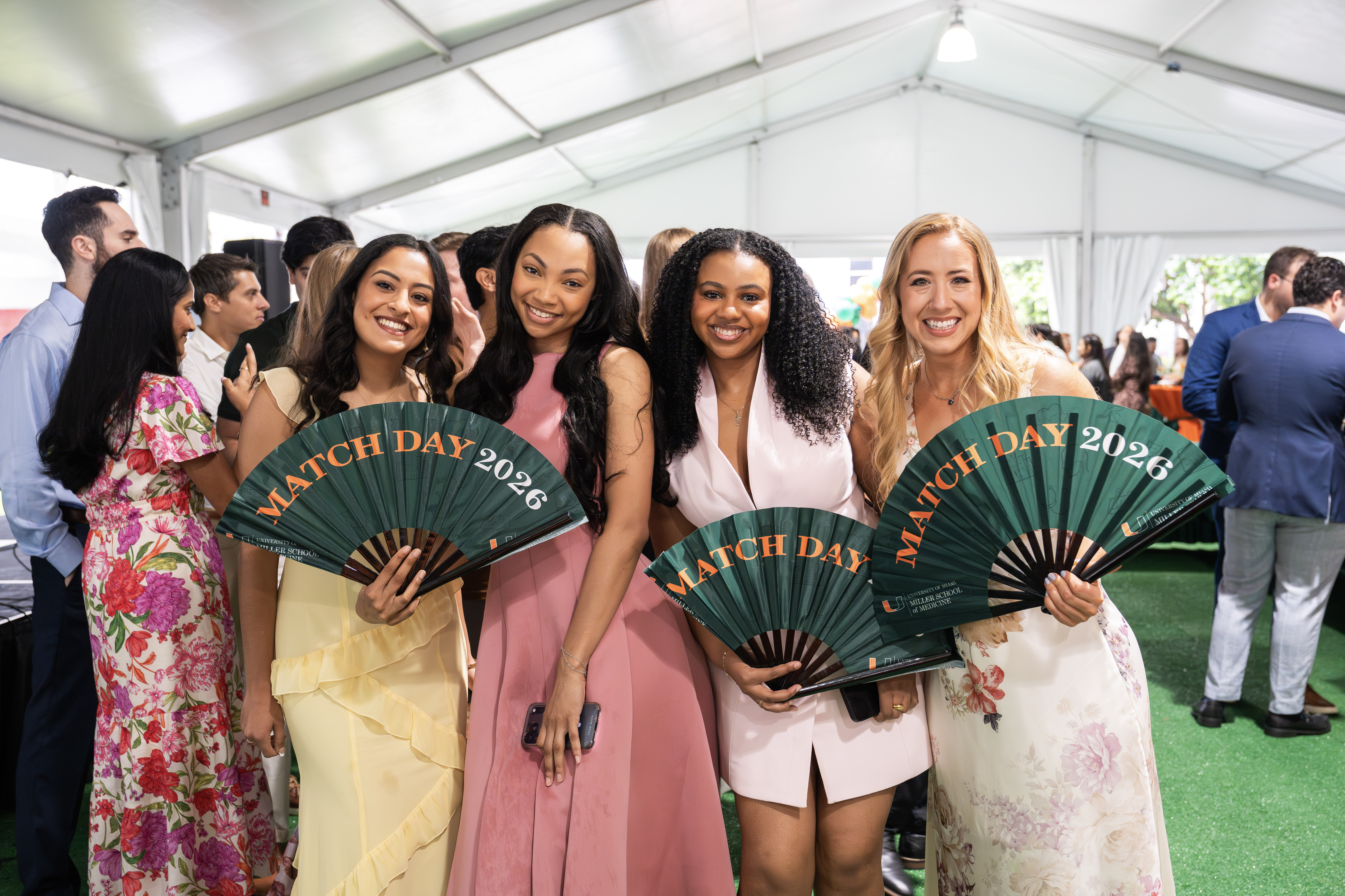 Four smiling women hold