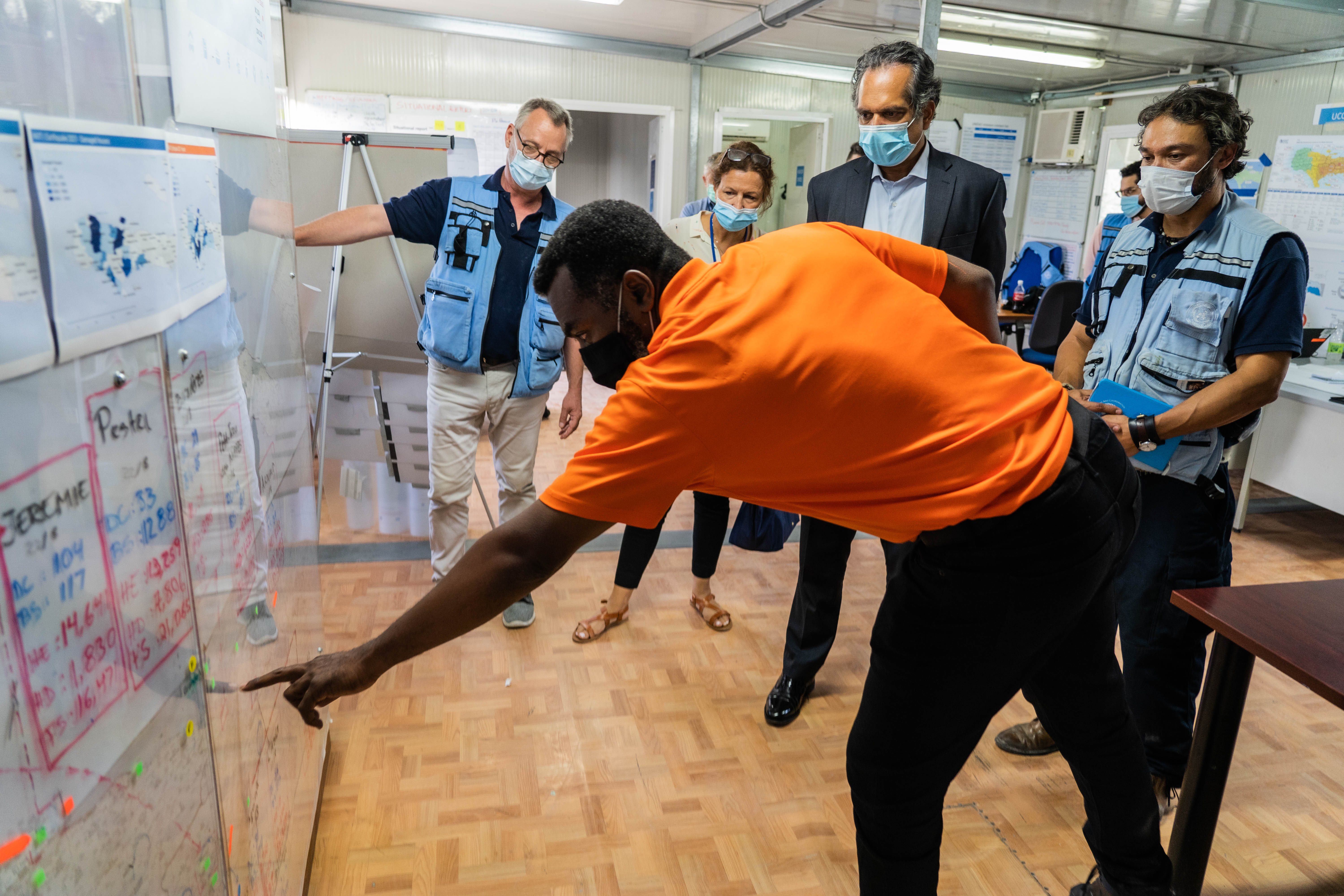 UN Deputy Emergency Relief Coordinator Ramesh Rajasingham is briefed by ...