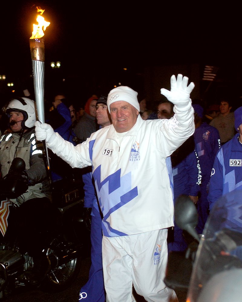 LaVell Edwards carries the Olympic Torch prior to the 2002 Salt Lake City Winter Games.