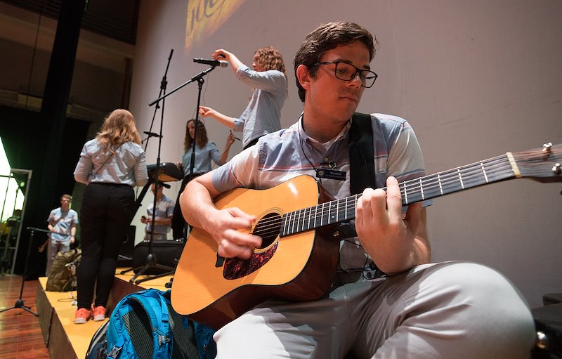 Marshall Gibson tunes his guitar in preparation for a performance at the Vietnam Dance Academy. Photo by Jaren Wilkey/BYU