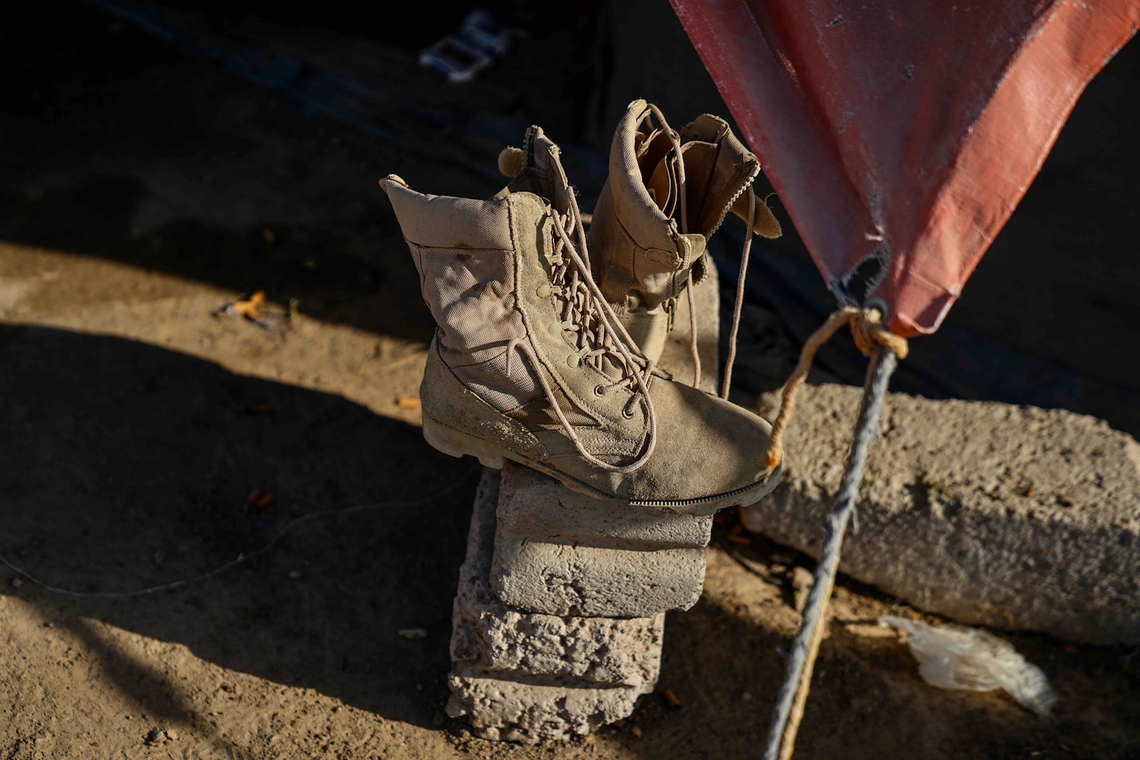 Boots outside a tent in a settlement on the outskirts of Marib in central Yemen. Well-made boots are an expensive and precious commodity for most migrants and refugees.