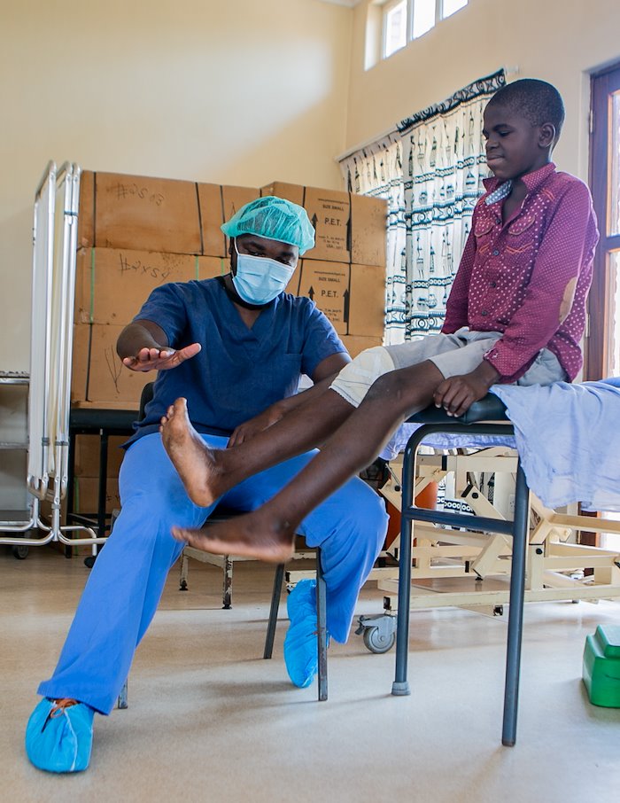 Our physical therapy team is helping Noel to properly bend his leg after receiving surgery.