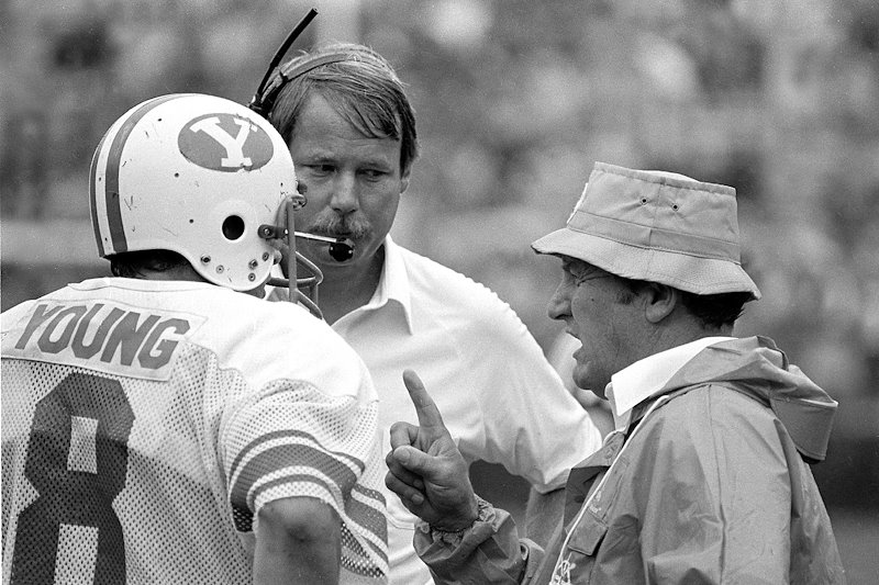 All-American quarterback Steve Young receives direction from Edwards, right, and quarterback coach Mike Holmgren.