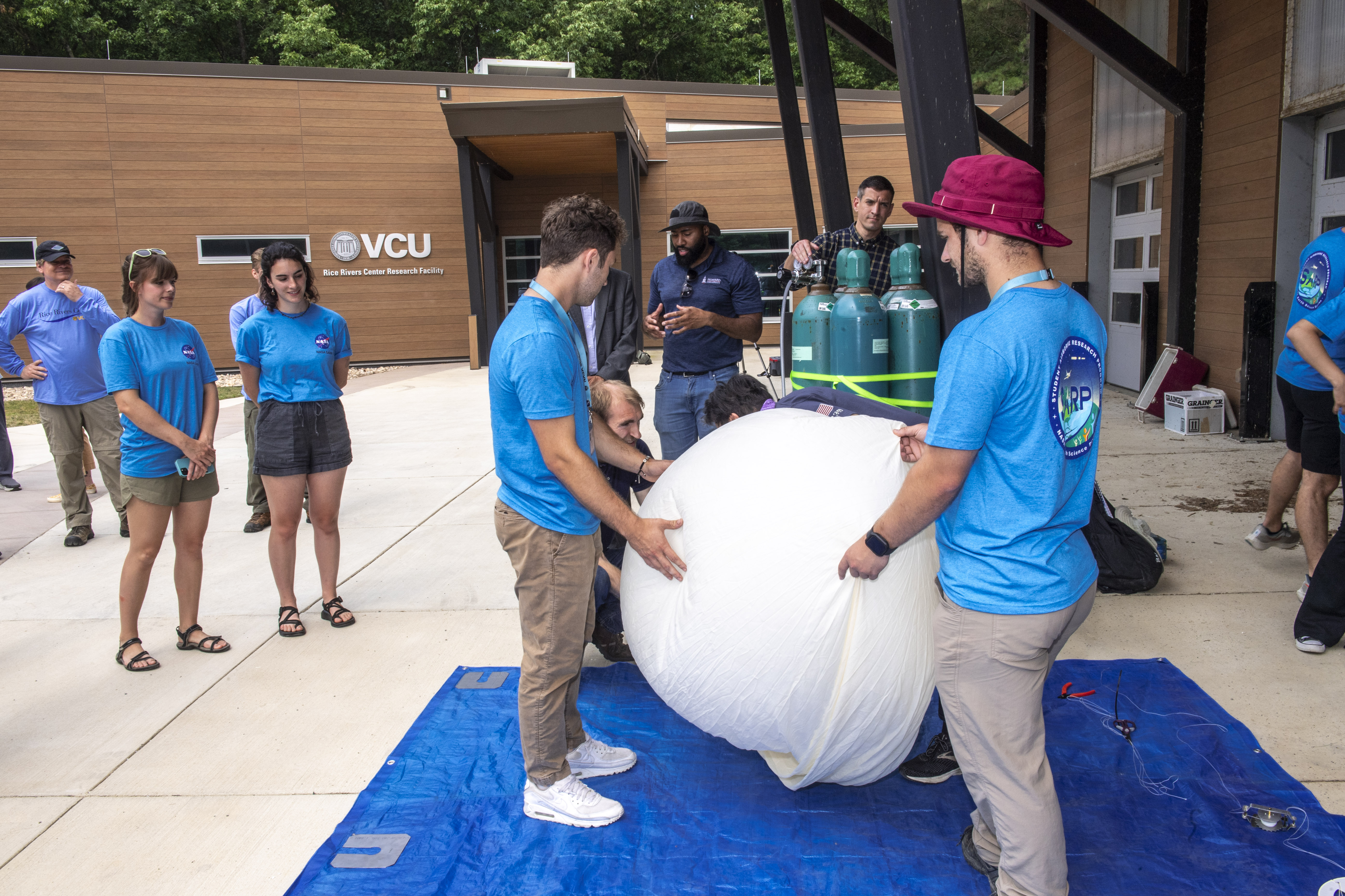 Students inflate an ozone sonde - a specialized type of weather balloon ...