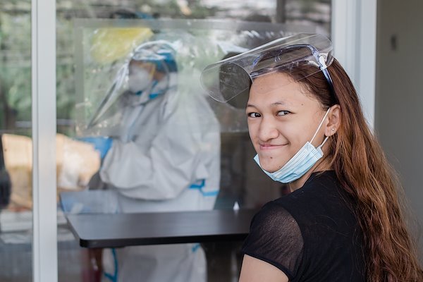 Michyle waits for her turn for a swab test.